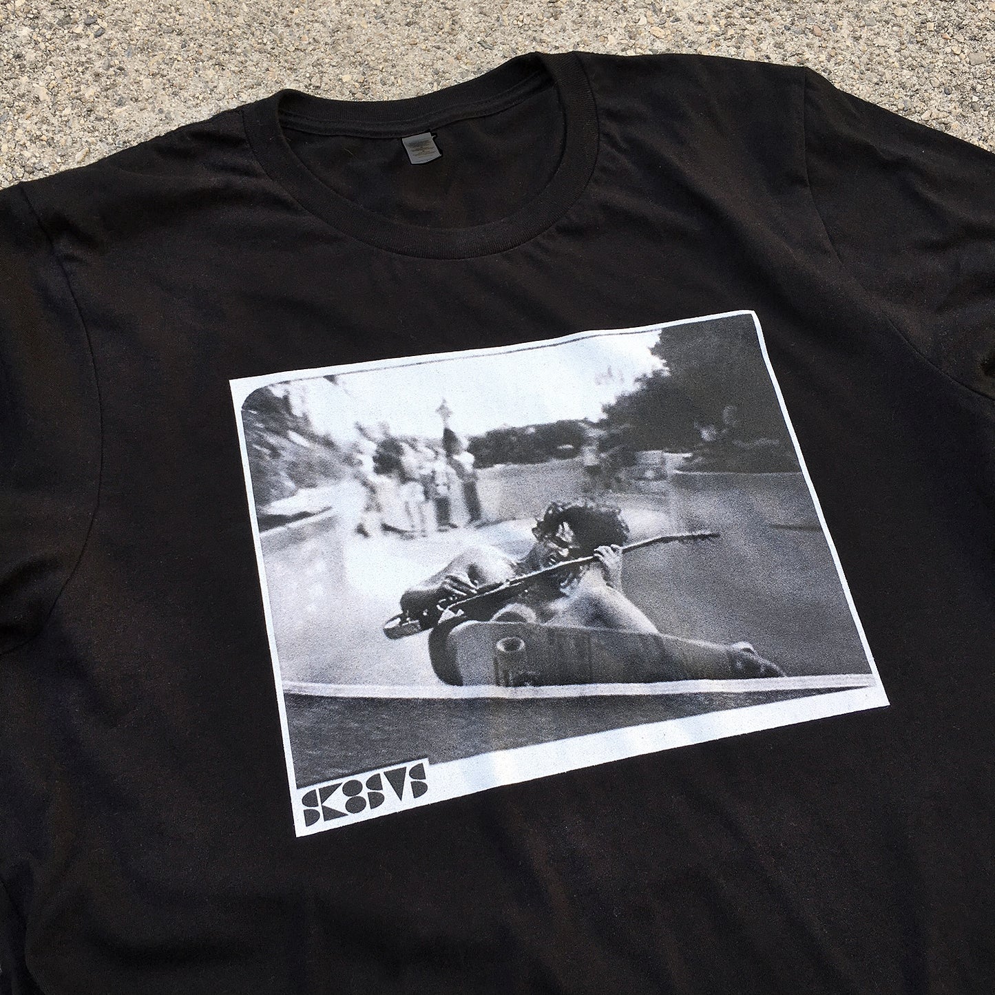 black skateboard tee shirt with a pool skater grinding while playing rock guitar acdc angus young streetwear custom diy