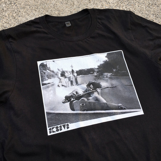 black skateboard tee shirt with a pool skater grinding while playing rock guitar acdc angus young streetwear custom diy